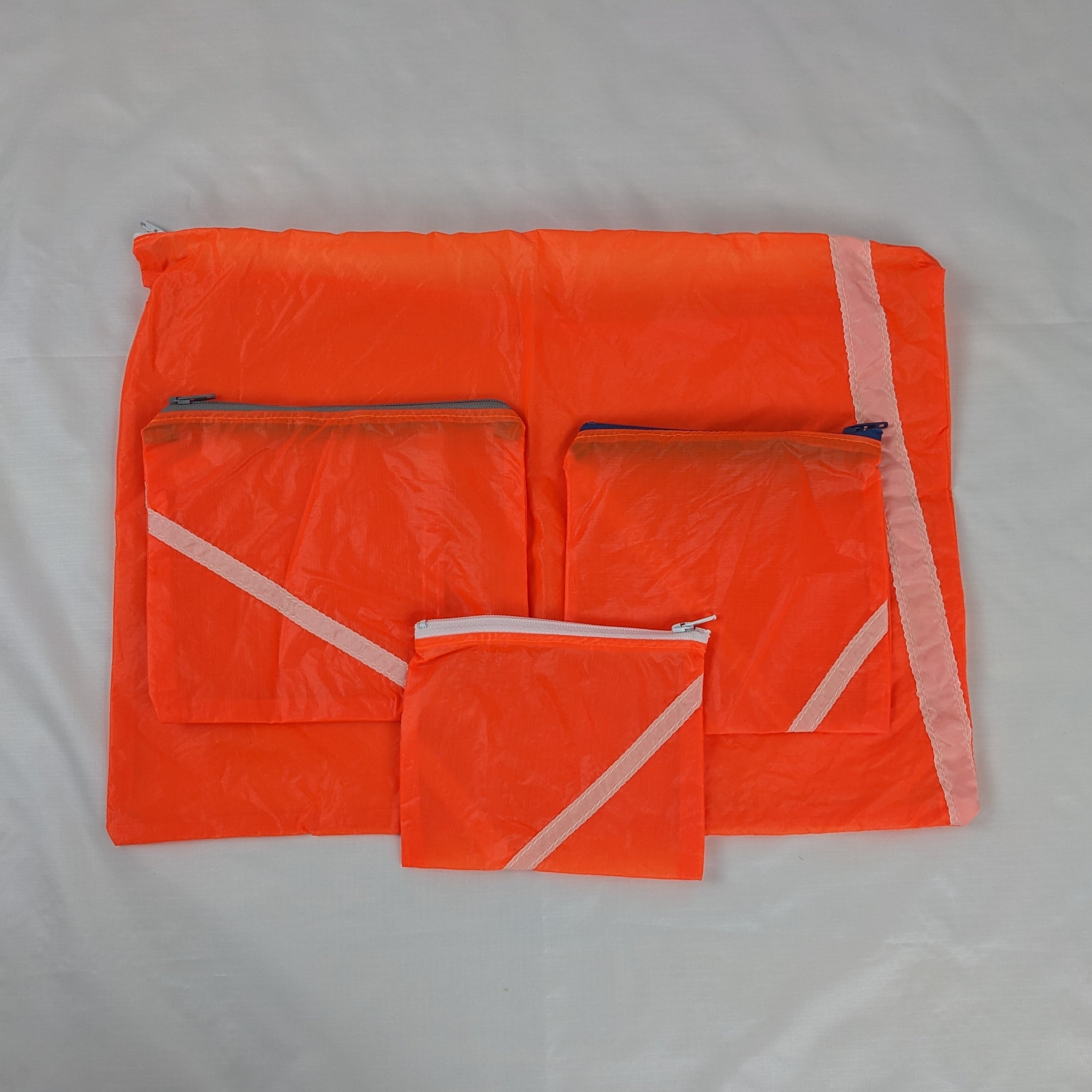 Four Repurposed Orange Zero Porosity Parachute Zipper Pouches