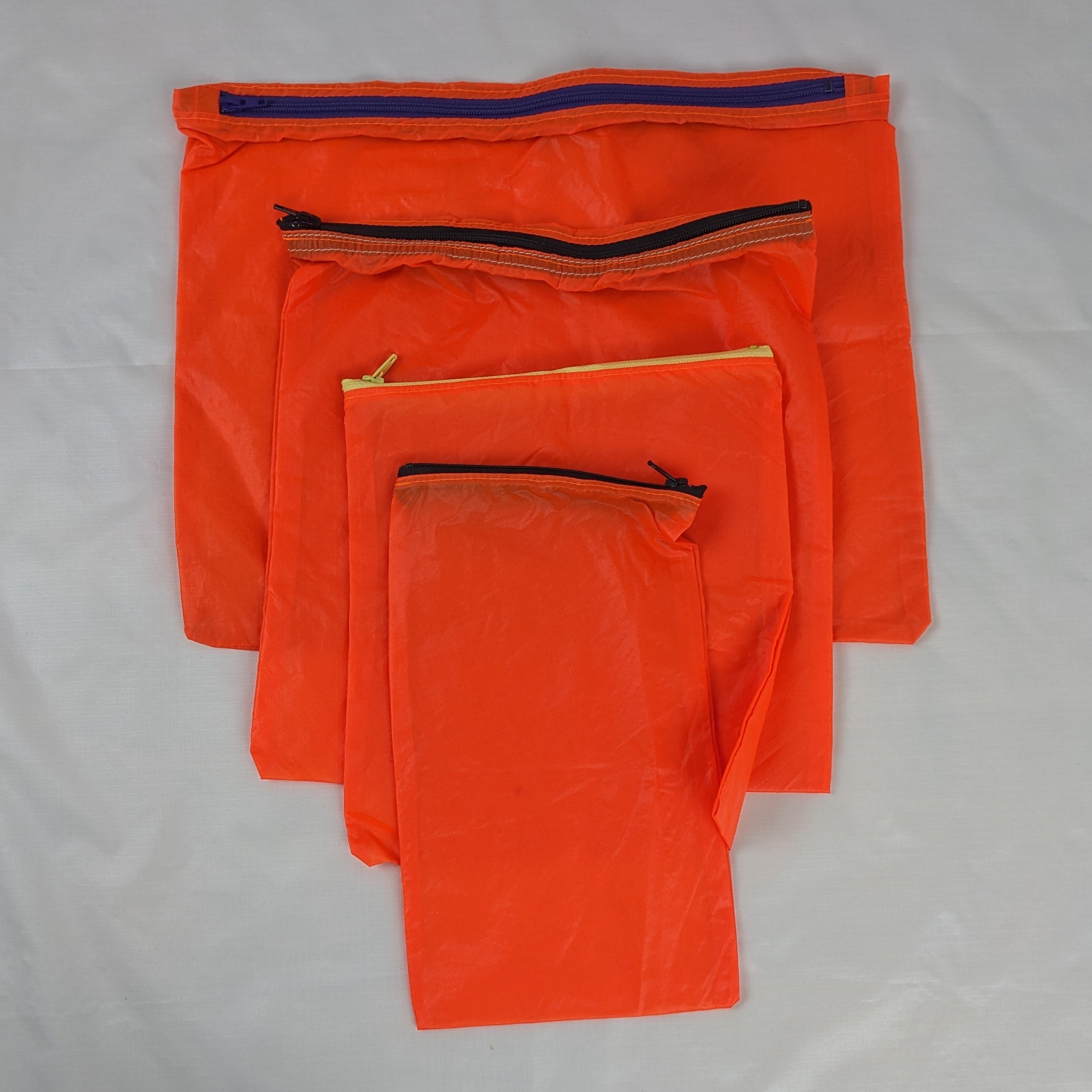 Four Orange Repurposed Water Resistant Parachute Zipper Pouches