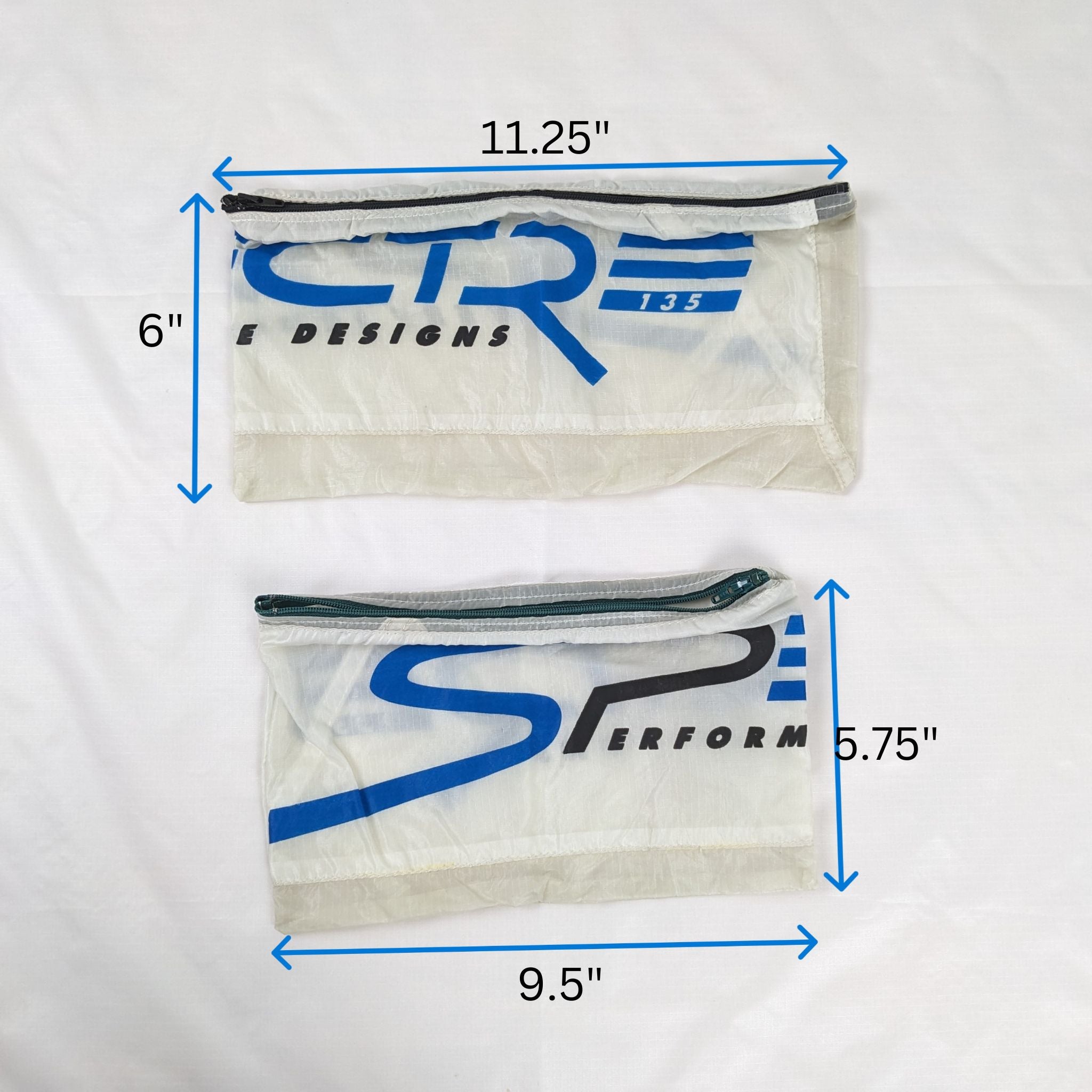 Two Spectre 135 White End Panel Zipper Pouches